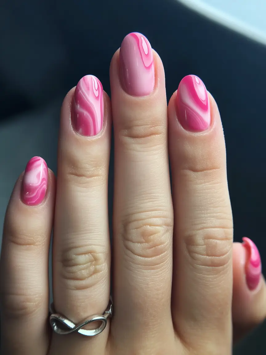 bold spring nails pink 2026 Swirled Pink Marble in Glossy Layers