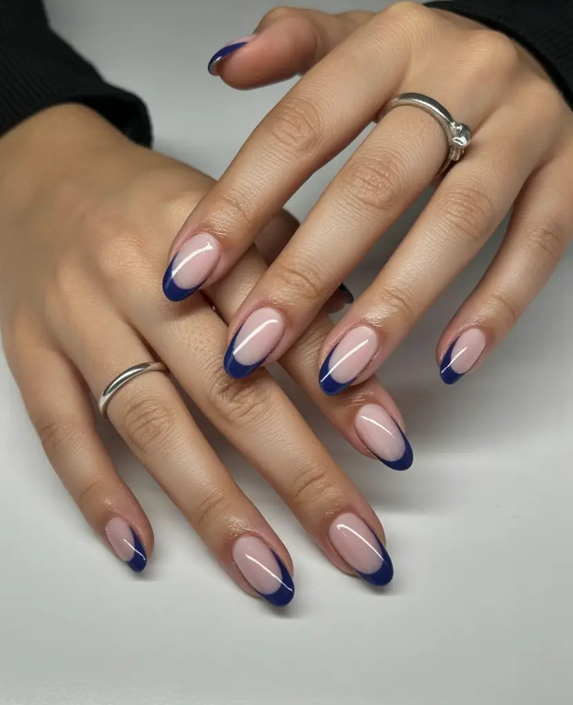 beautiful spring oval nails 2026 Classic Nude Base with Bold Blue French Tips