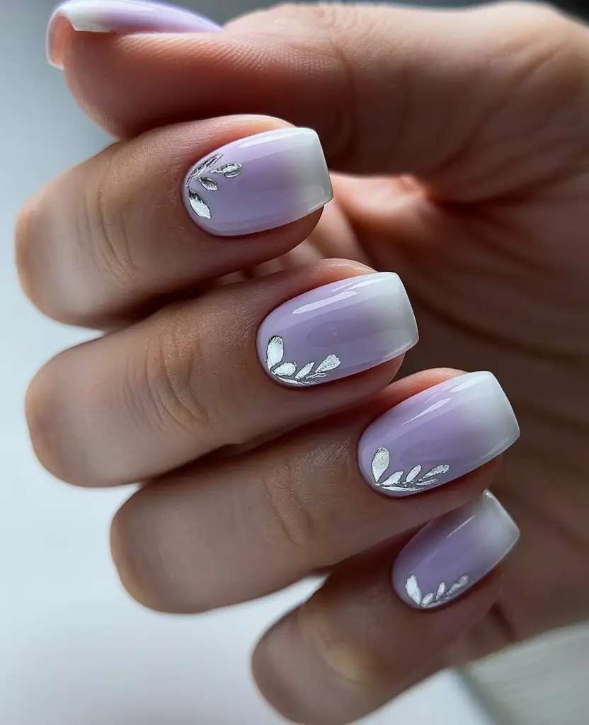 graduation nail color ideas 2026 Soft lilac gradient manicure with silver leaf accents