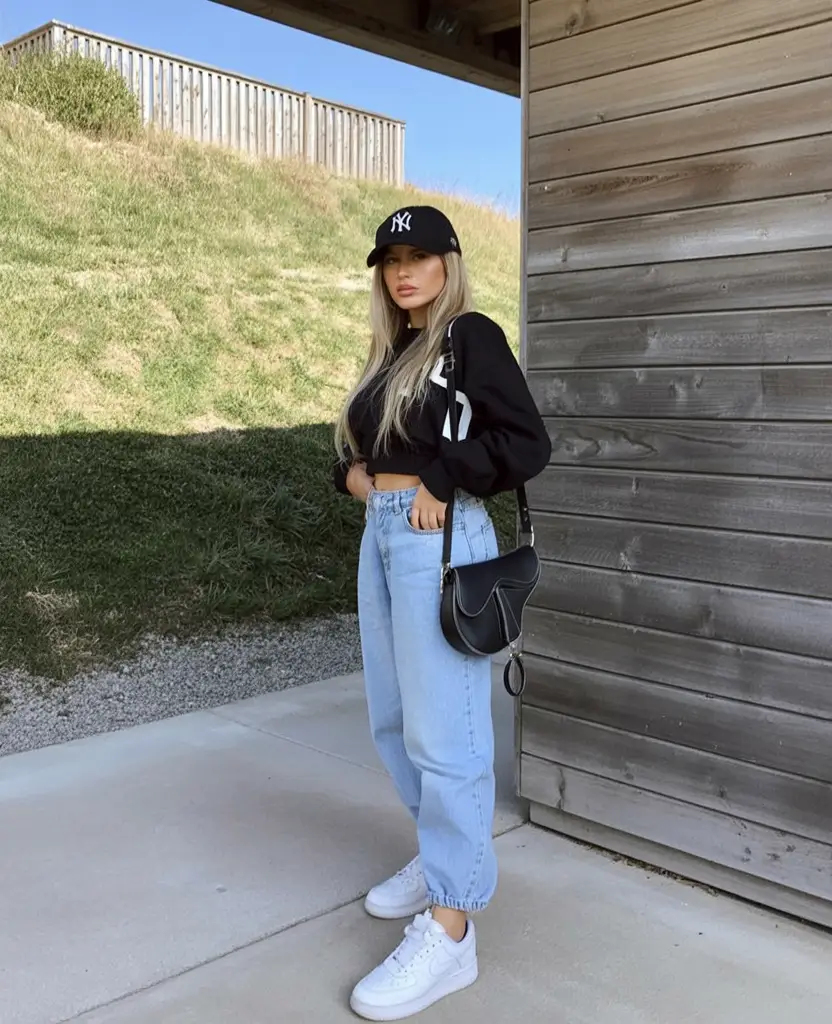 summer outfits with sneakers for women 2026 Black crop top and light blue jeans relaxed street style mood