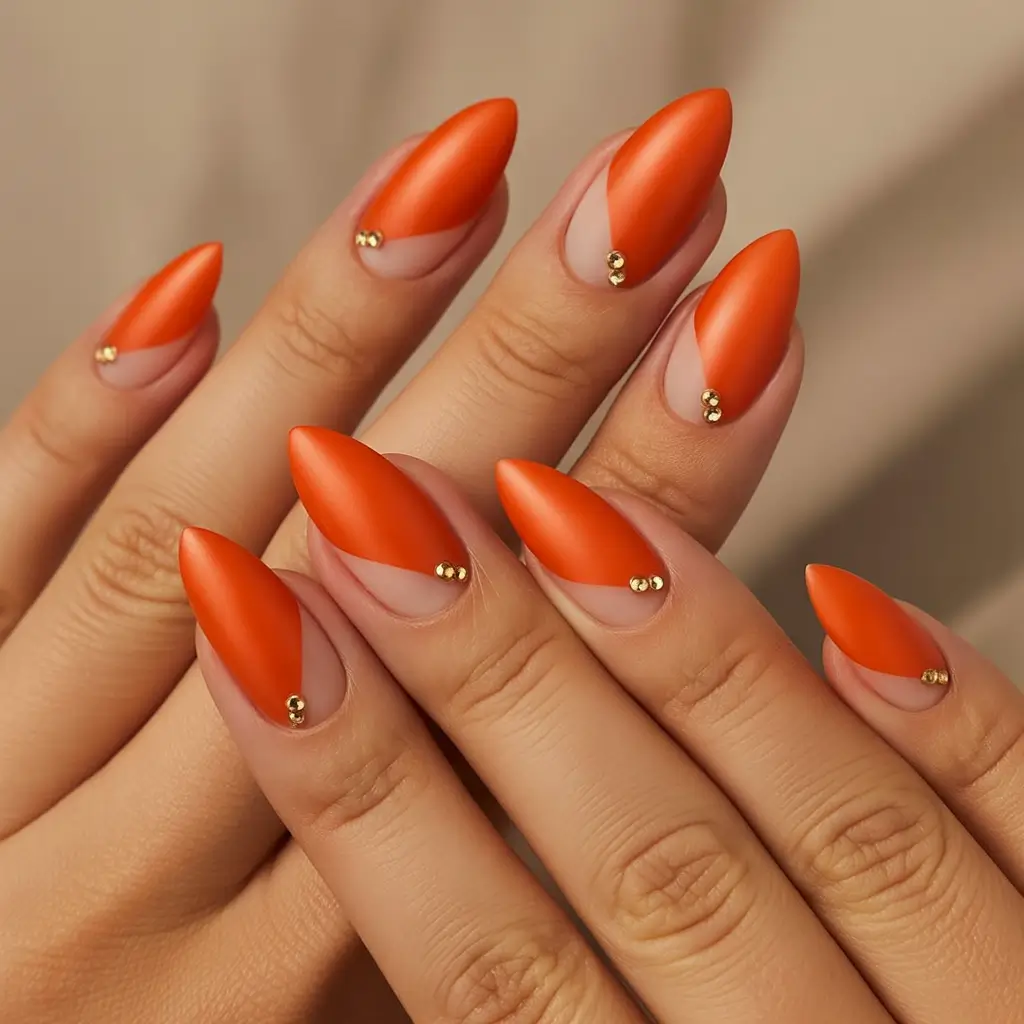 vibrant spring orange nails 2026 Matte Tangerine Almond with Gold Stud Detail