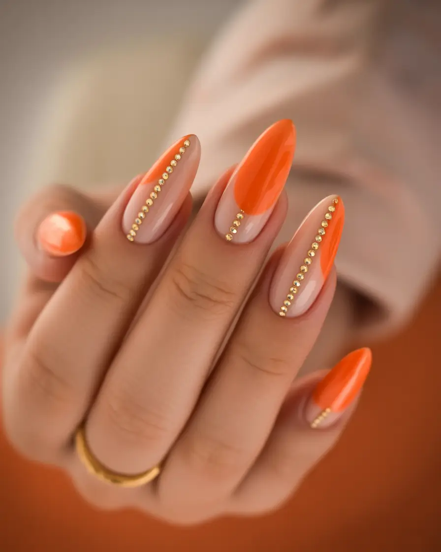 vibrant spring orange nails 2026 Glossy Almond with Gold Stud Vertical Detail