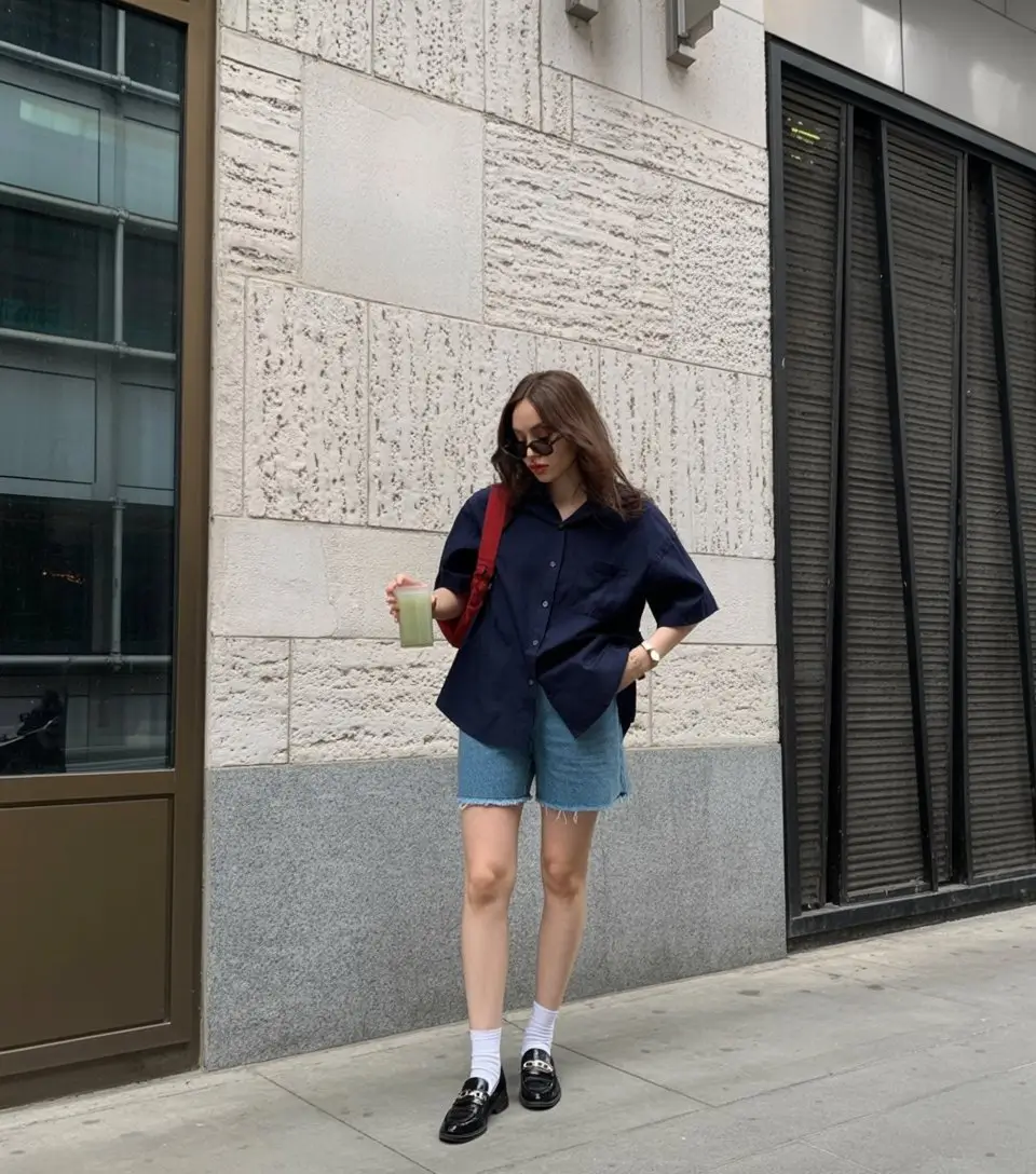 chic summer work outfits 2026 Oversized shirt and denim shorts for city ready comfort