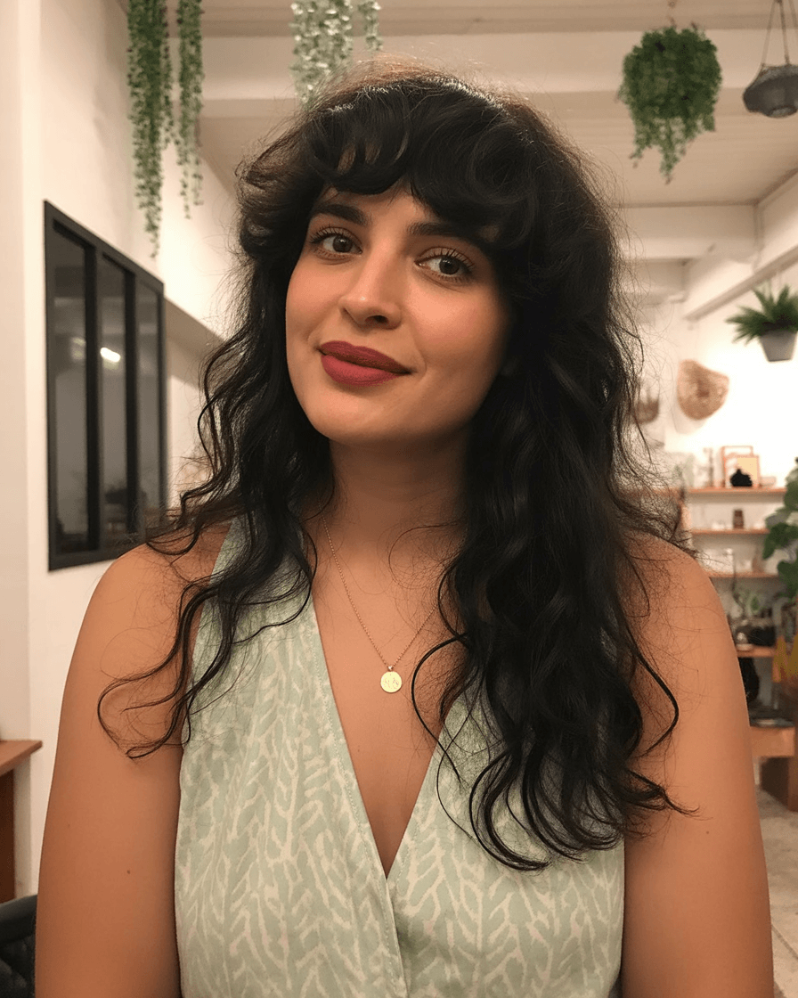 flattering summer haircuts for plus size women 2026 Long shaggy waves with soft bangs and natural texture