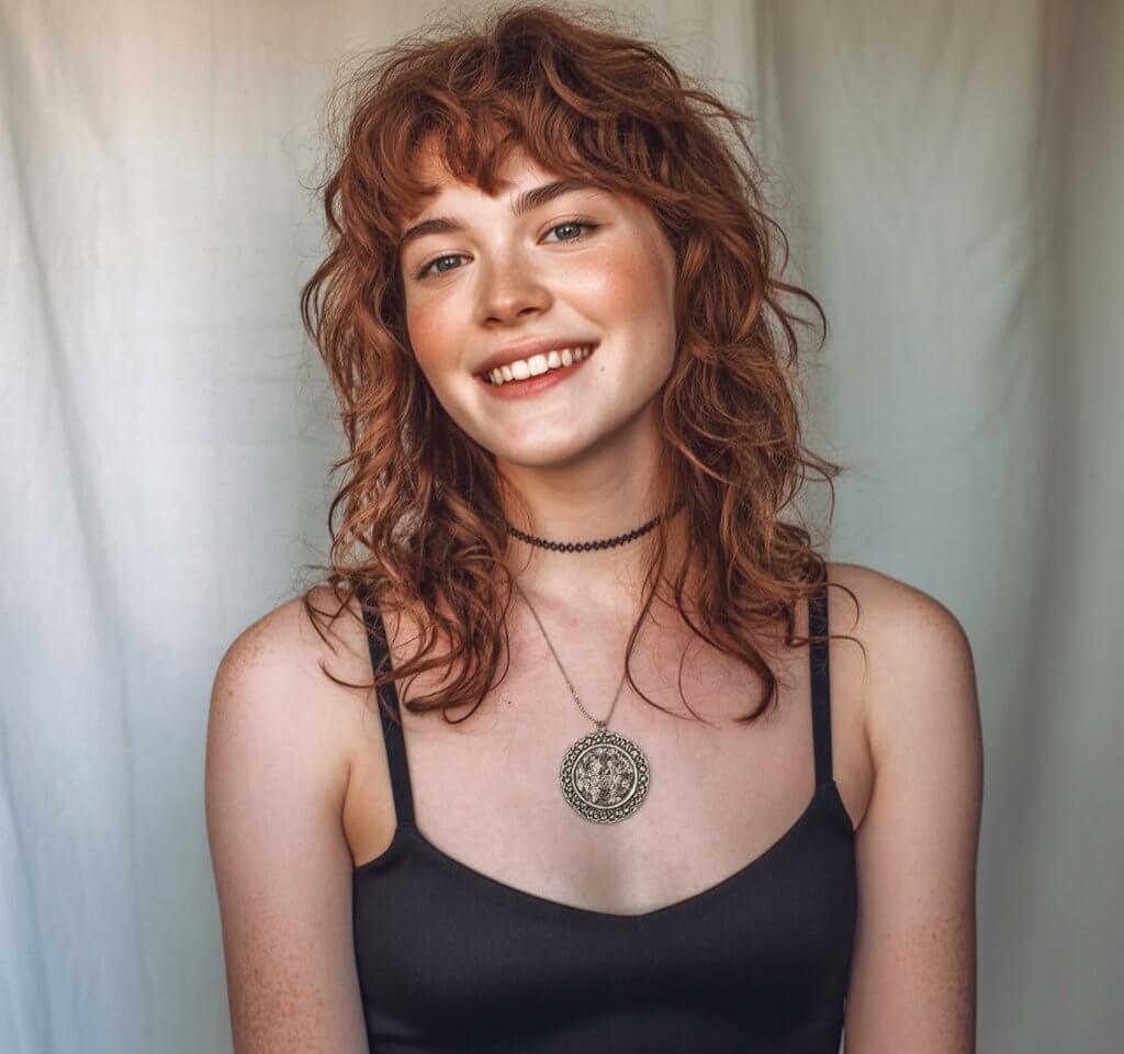 layered summer haircuts for medium hair 2026 Curly layered shag with soft fringe energy