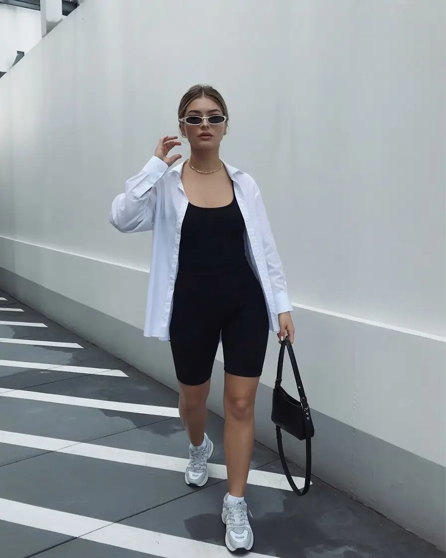 Summer Romper Outfits For Women 2026 Minimal black romper with oversized shirt and sneakers energy