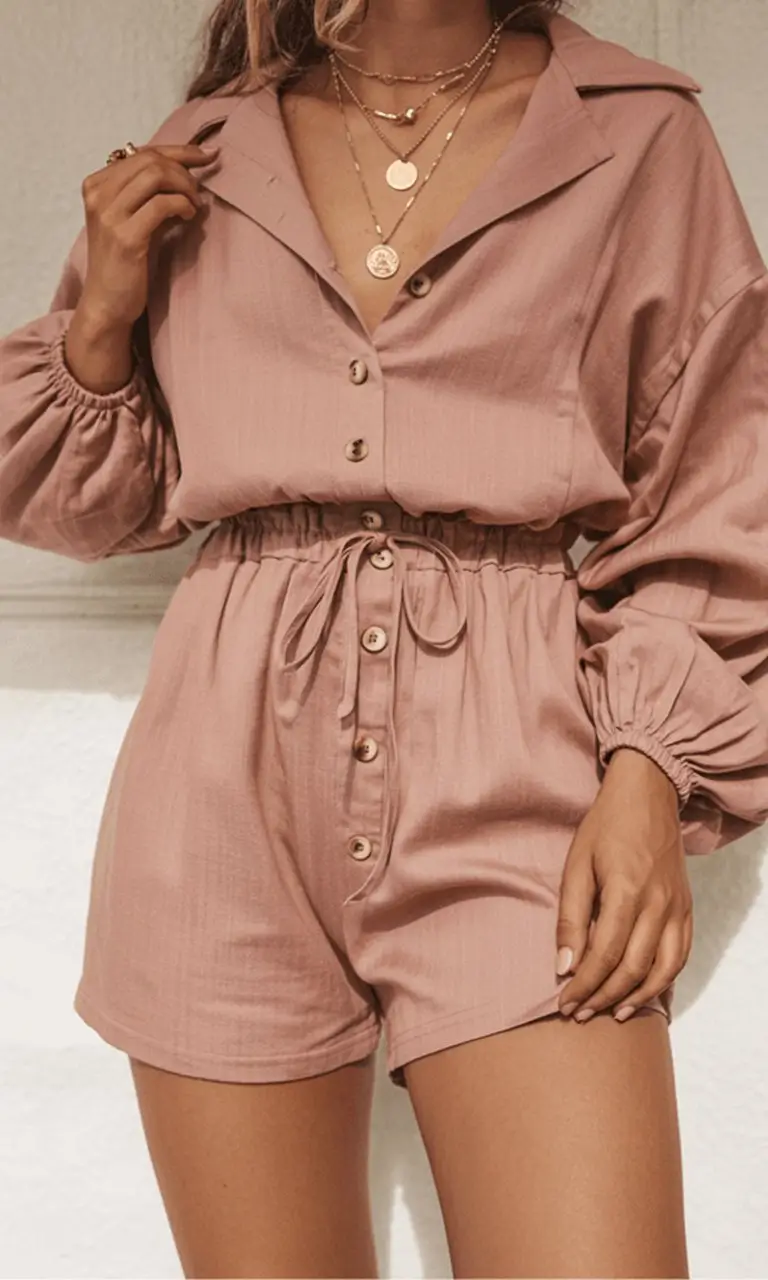 Summer Romper Outfits For Women 2026 Soft pink buttoned romper with relaxed silhouette for feminine ease