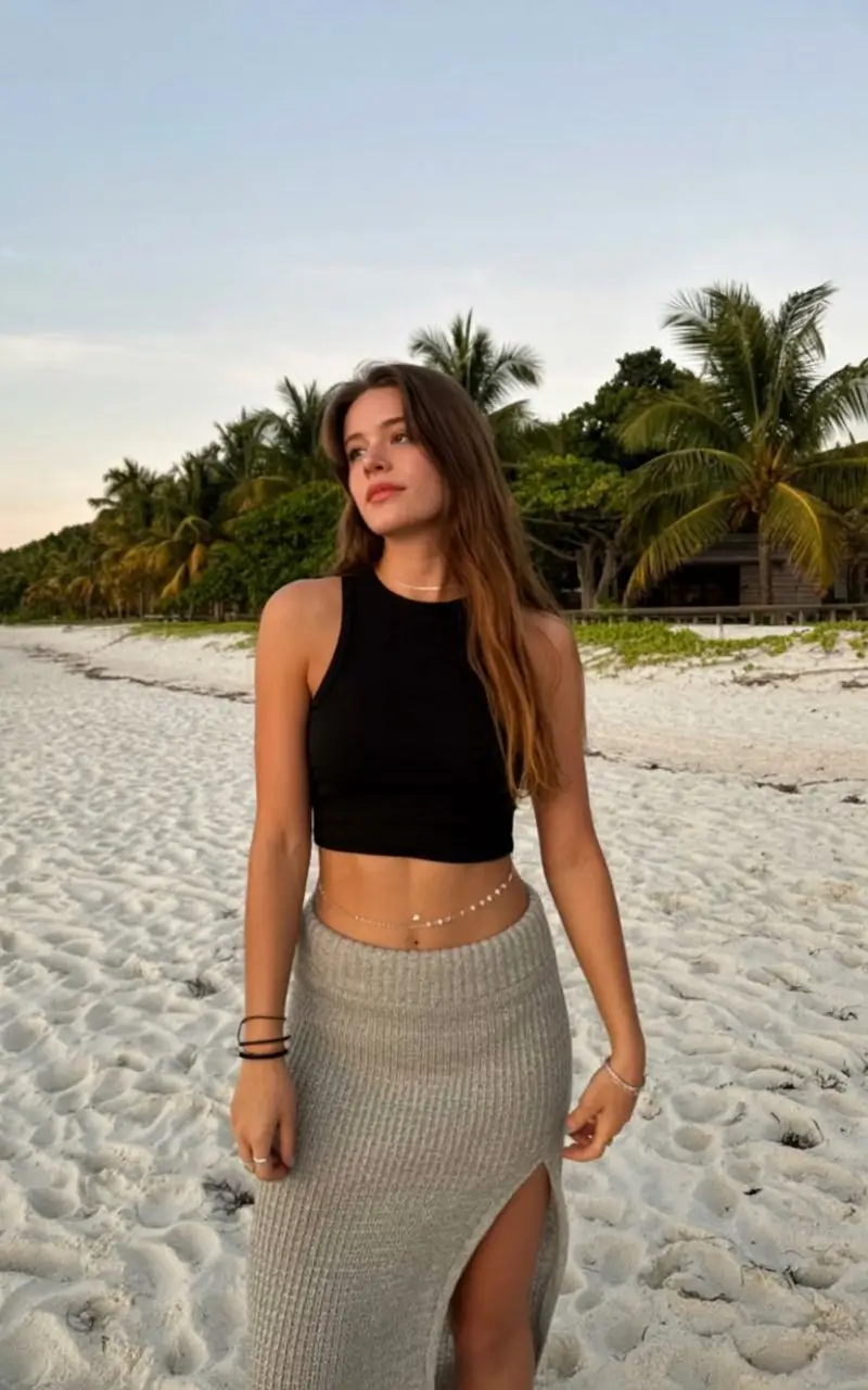 summer sleeveless tops for women 2026 Minimal black crop with soft knit skirt at sunset