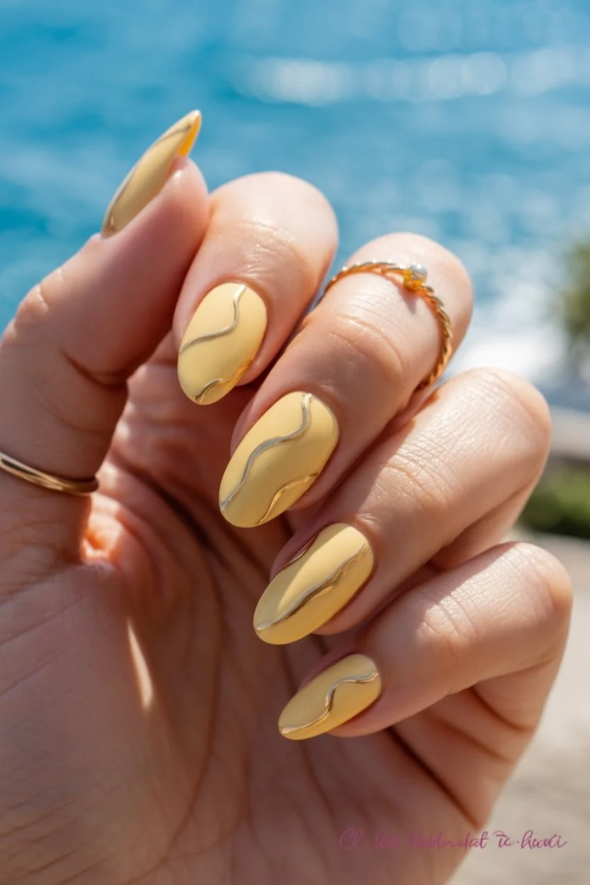 Summer yellow nails 2026 Soft Butter Yellow With Liquid Metal Waves