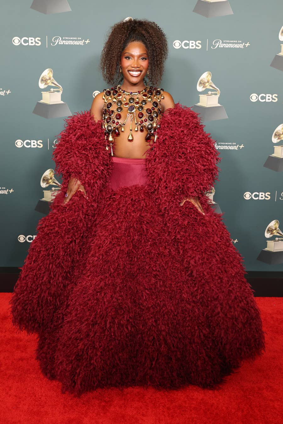 Deep Red Gown with Textured Sleeves and Faux Fur Skirt — Aesthetic Red Carpet Dresses