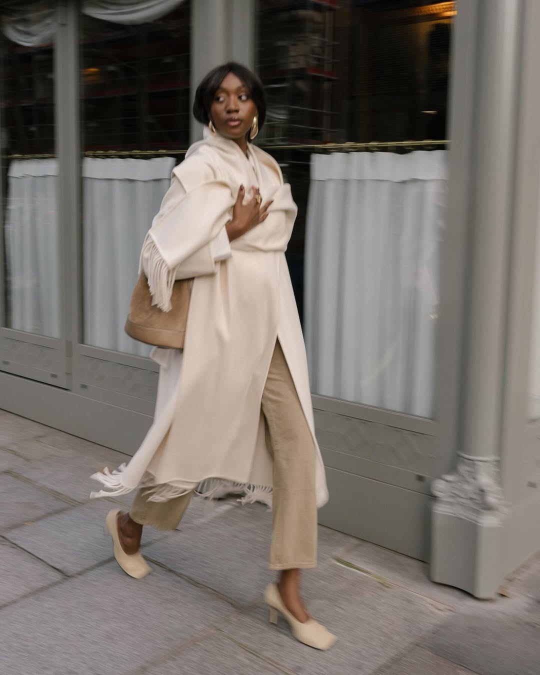 Cream Long Coat with Fringe Over Beige Layers and Tan Trousers — Classy Beige Outfits
