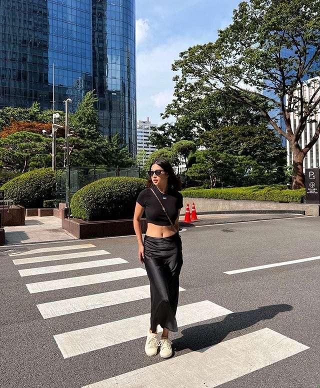 Black Satin Slip Midi Skirt With Cropped Tee and White Sneakers — Classy Black Midi Skirt Outfit
