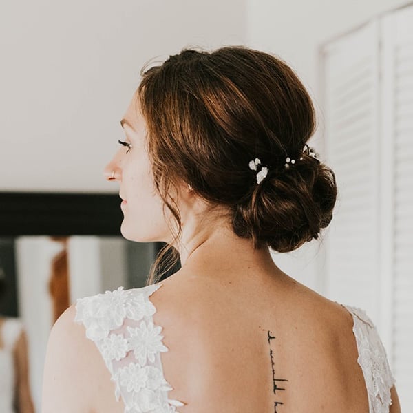 Sleek Dark Brown Low Bun With Pins Sleek Dark Brown Low Bun With Pins — Classy Bridal Bun