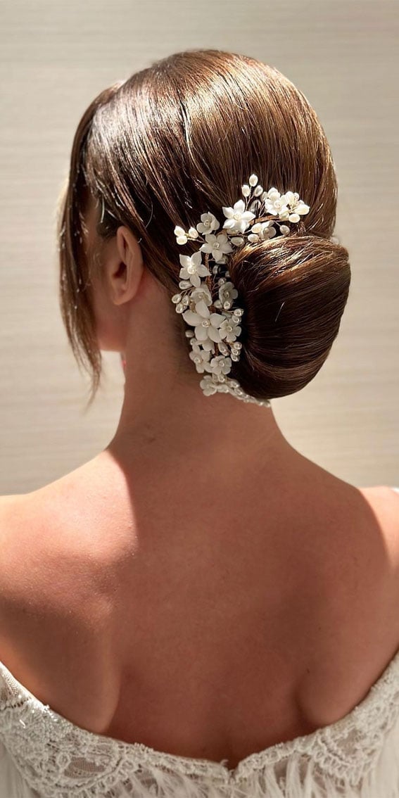 Textured Dark Brown Bun With Floral Accent Textured Dark Brown Bun With Floral Accent — Classy Bridal Bun