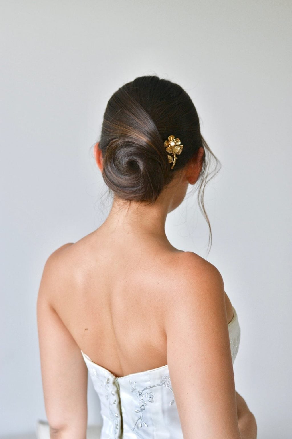 Smooth Dark Brown Bun With Gold Accessory Smooth Dark Brown Bun With Gold Accessory — Classy Bridal Bun