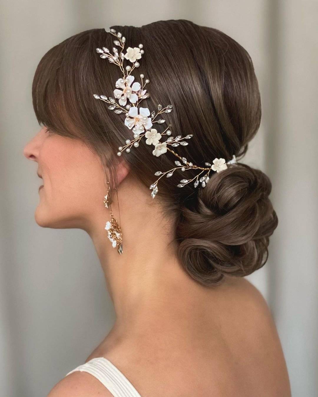 Low Bun With Ornate Accessory And Curtain Bangs — Classy Bun and Bang