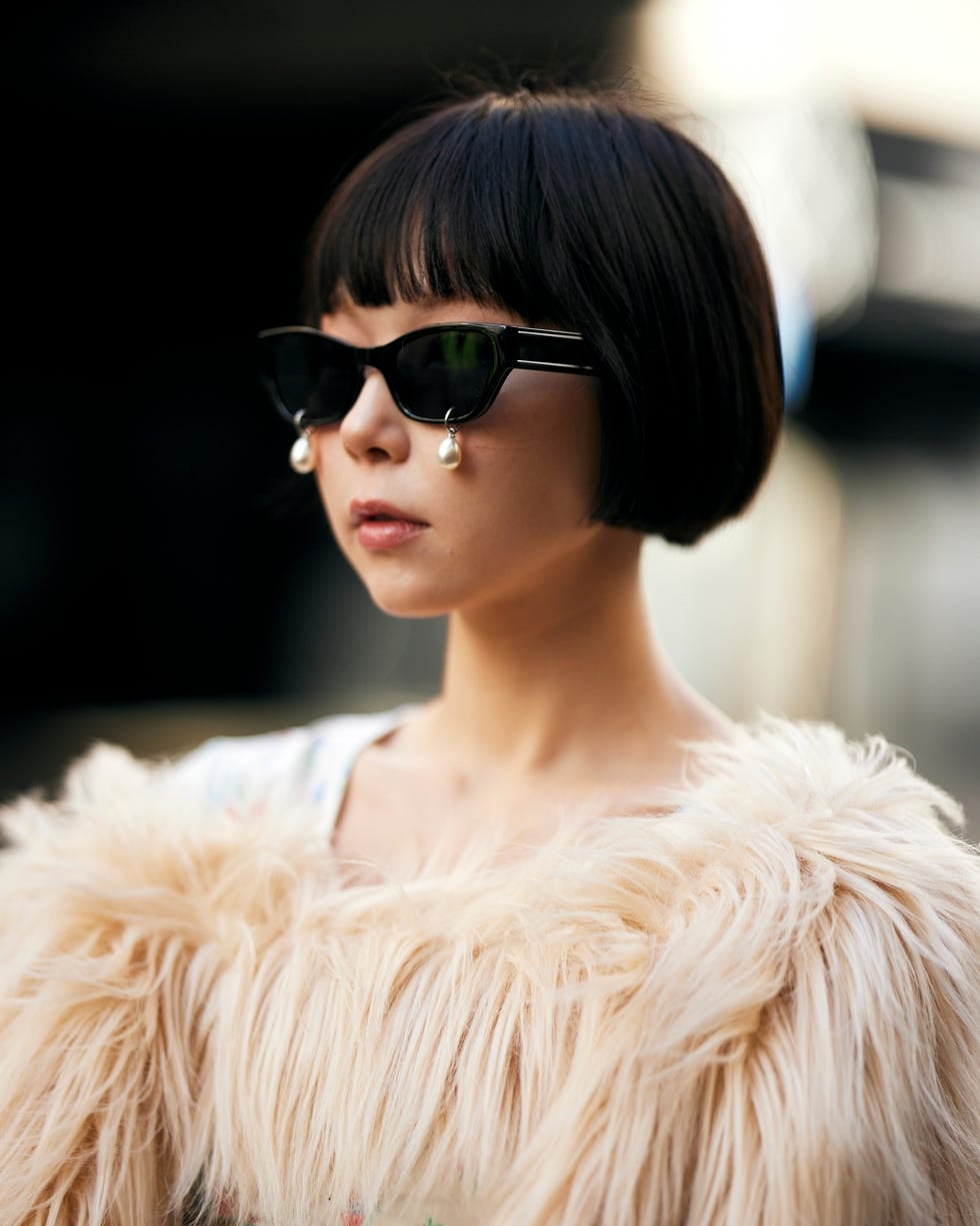 Black Chin-Length Bob Tucked Behind Ears Black Chin-Length Bob Tucked Behind Ears — Classy French Bob with Bangs