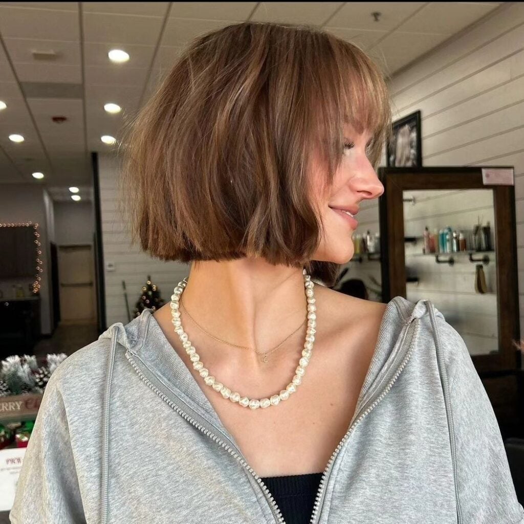 Classic Chin-Length Dark Brown Bob With Blunt Bangs, Close-Up Take Classic Chin-Length Dark Brown Bob With Blunt Bangs, Close-Up Take — Classy French Bob with Bangs