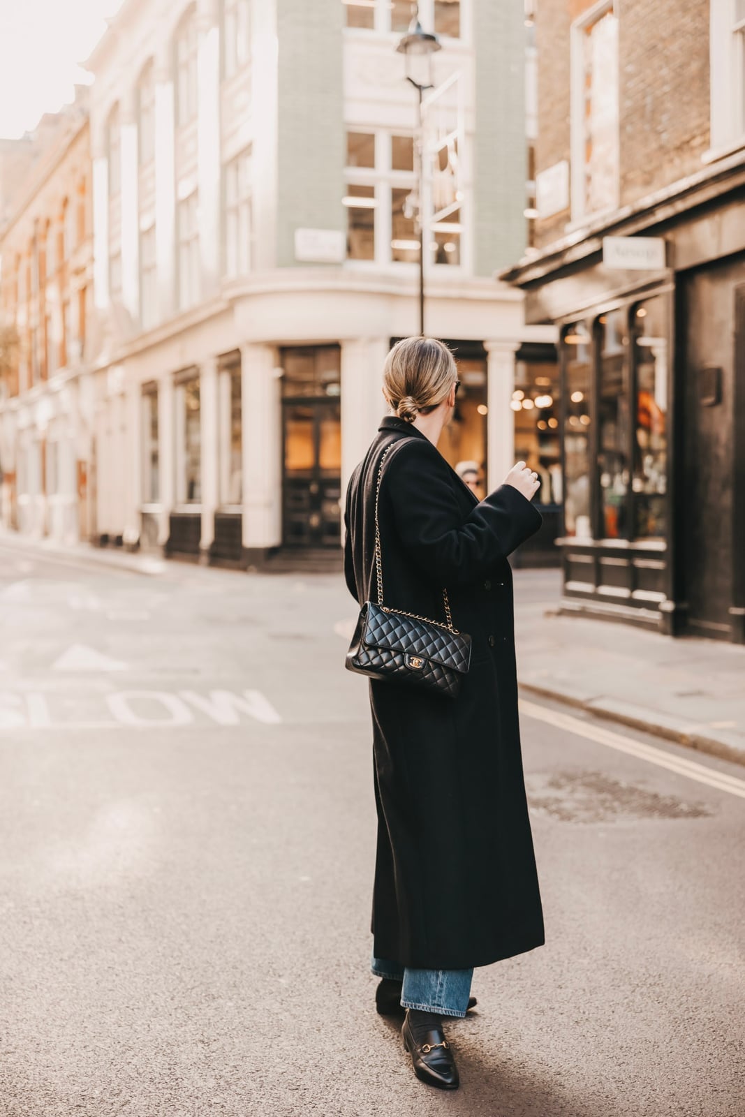 Long Black Wool Coat Over Quilted Jacket And Jeans Long Black Wool Coat Over Quilted Jacket And Jeans — Classy London Outfits