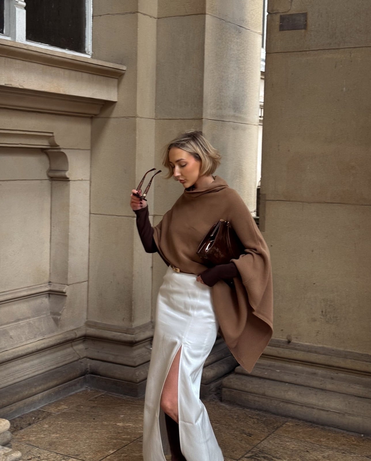 White Satin Maxi Skirt with High Slit and Brown Knit Poncho — Classy Long Skirt Outfits