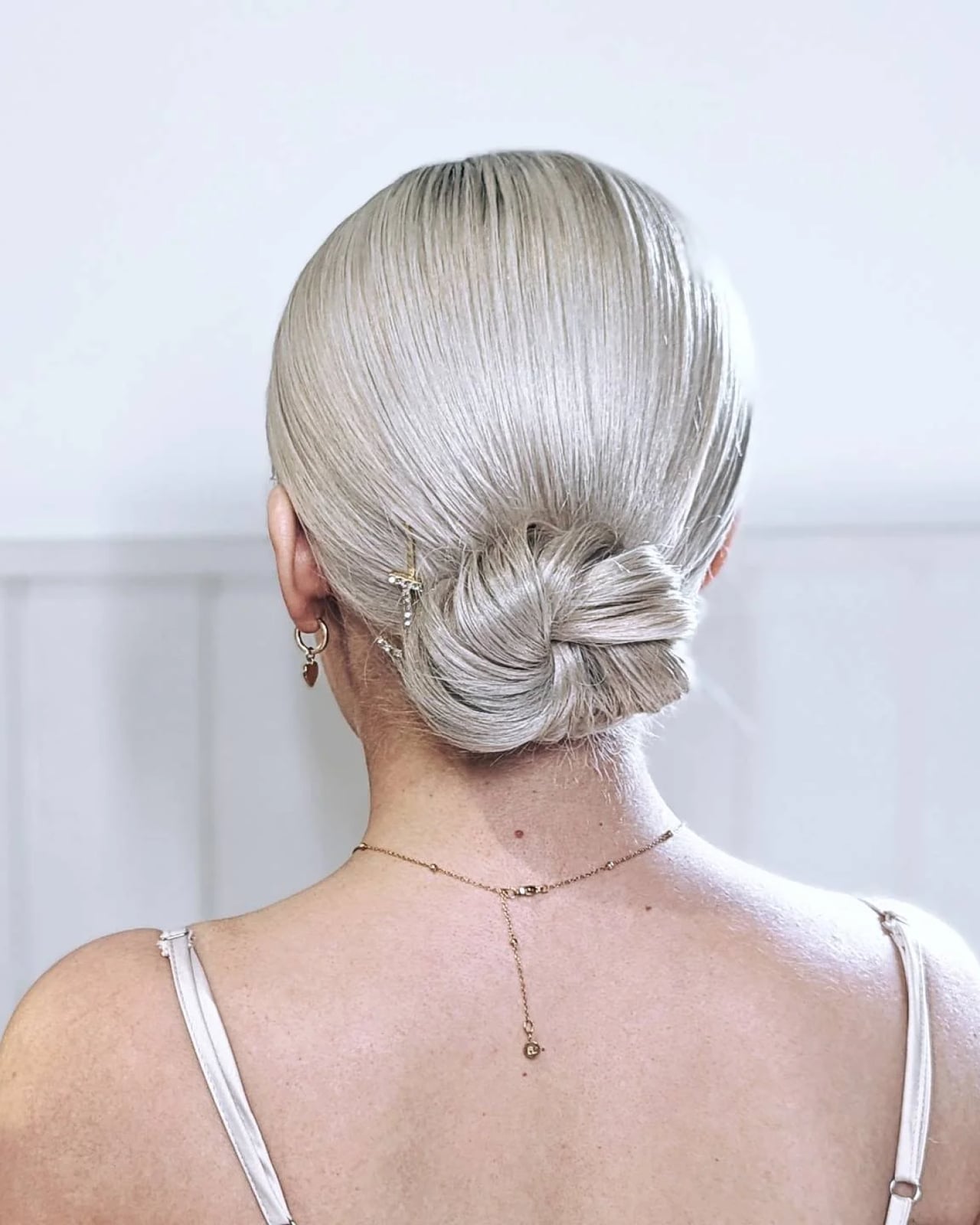Platinum Blonde Sleek Low Bun, Long Platinum Blonde Sleek Low Bun, Long — Classy Professional Hairstyles