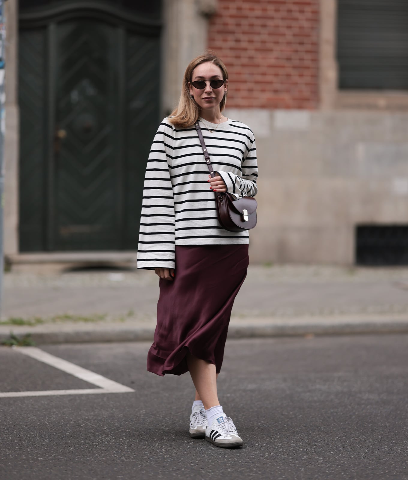 Burgundy Satin Midi Skirt With Striped Sweater And Sneakers Burgundy Satin Midi Skirt With Striped Sweater And Sneakers — Classy Silk Skirt Outfit