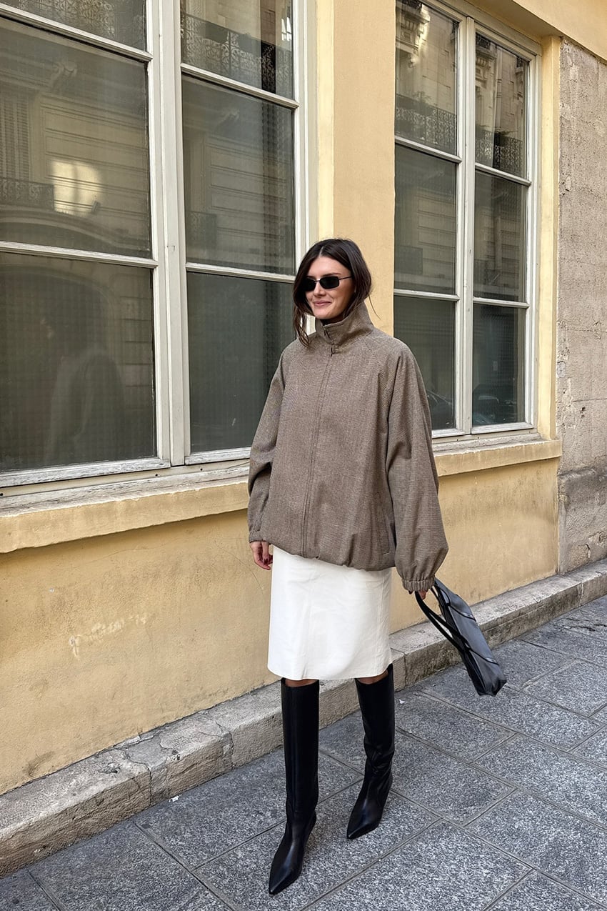 White Mini Skirt With Oversized Brown Jacket and Black Knee-High Boots — Classy Slip Skirt Outfits