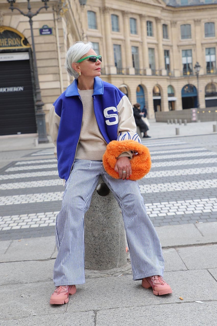 Blue and Cream Varsity Jacket with Beige Sweater and Striped Pants — Classy Varsity Jacket Outfits
