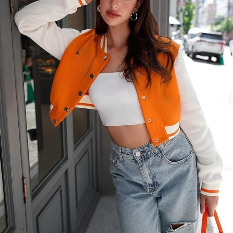 Cropped Orange and White Varsity Jacket with Crop Top and Jeans — Classy Varsity Jacket Outfits