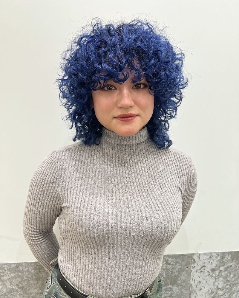 Collarbone Vibrant Blue Mullet With Curtain Bangs, Close-Up Take Collarbone Vibrant Blue Mullet With Curtain Bangs, Close-Up Take — Curly Hair Dye Styles