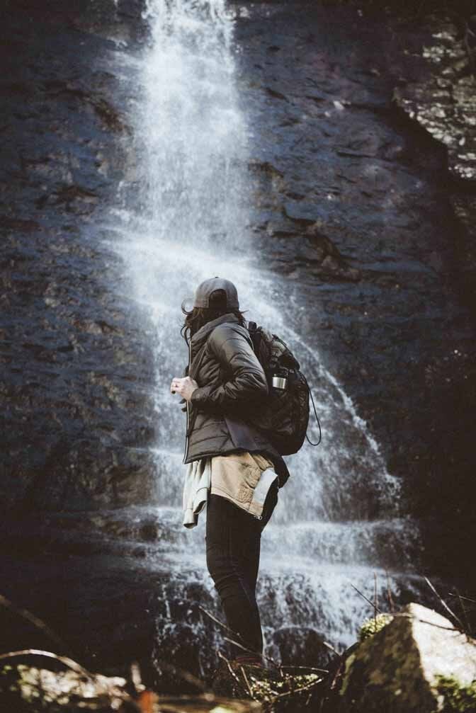Dark Hooded Jacket Over Beige Shirt And Pants Dark Hooded Jacket Over Beige Shirt And Pants — Cute Hiking Outfit Inspo