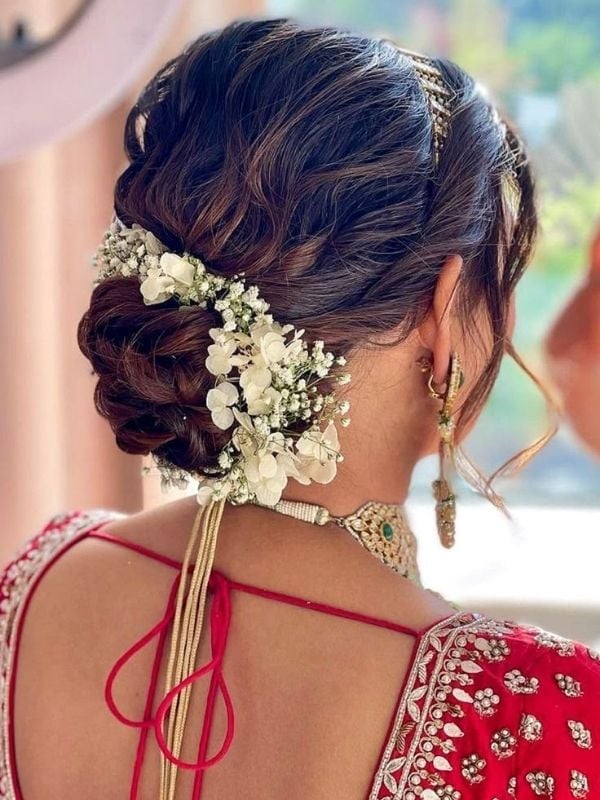 Dark Brown Low Bun With Abundant Floral Embellishments — Easy Wedding Hairstyles for Long Hair