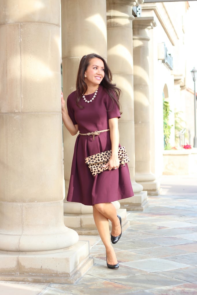 Burgundy A-line Dress with Gold Belt and Leopard Clutch, Close-Up Take Burgundy A-line Dress with Gold Belt and Leopard Clutch, Close-Up Take — Elegant Burgundy Dress Outfit