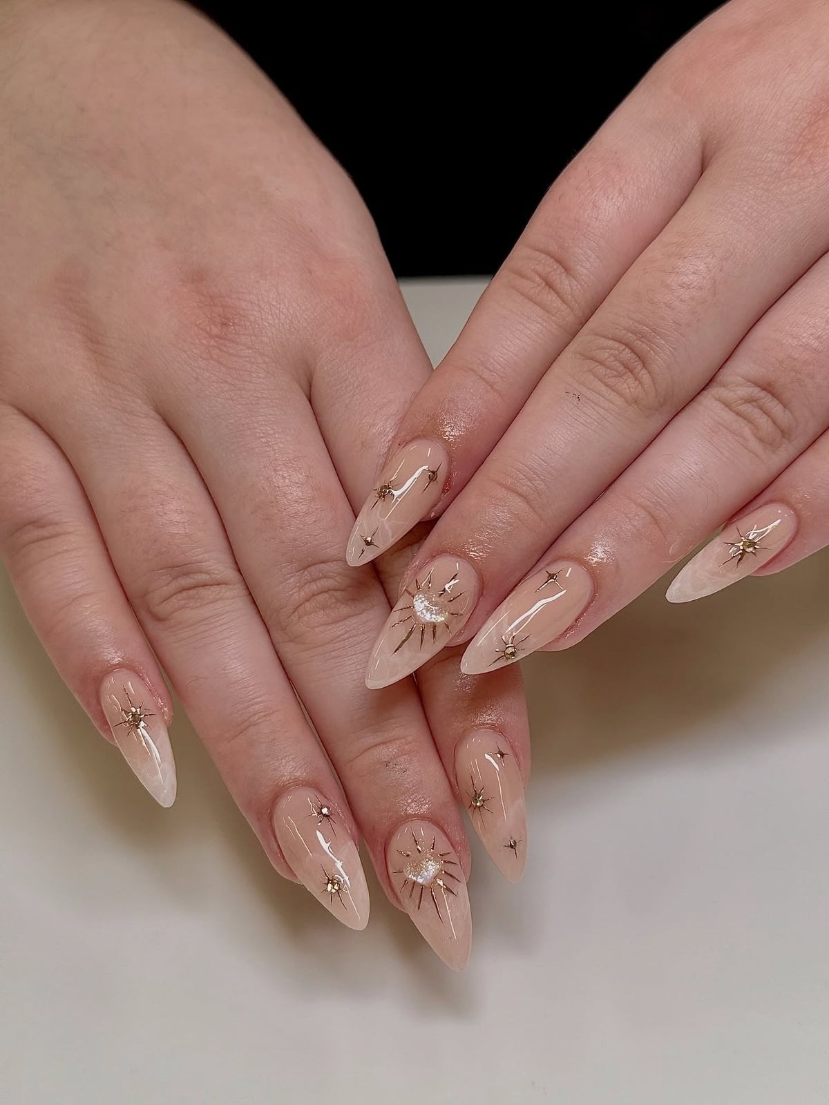 Medium Stiletto Nude With Gold Celestial Motifs Medium Stiletto Nude With Gold Celestial Motifs — Simple Champagne Nails