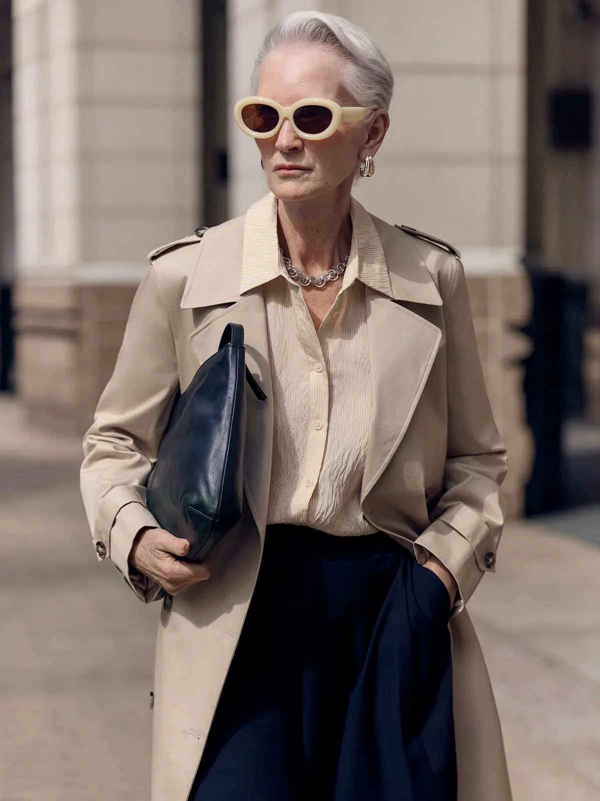 A Beige Trench Coat Layers a Cream Textured Shirt and Navy Trousers A Beige Trench Coat Layers a Cream Textured Shirt and Navy Trousers — Simple Corporate Outfits for Women
