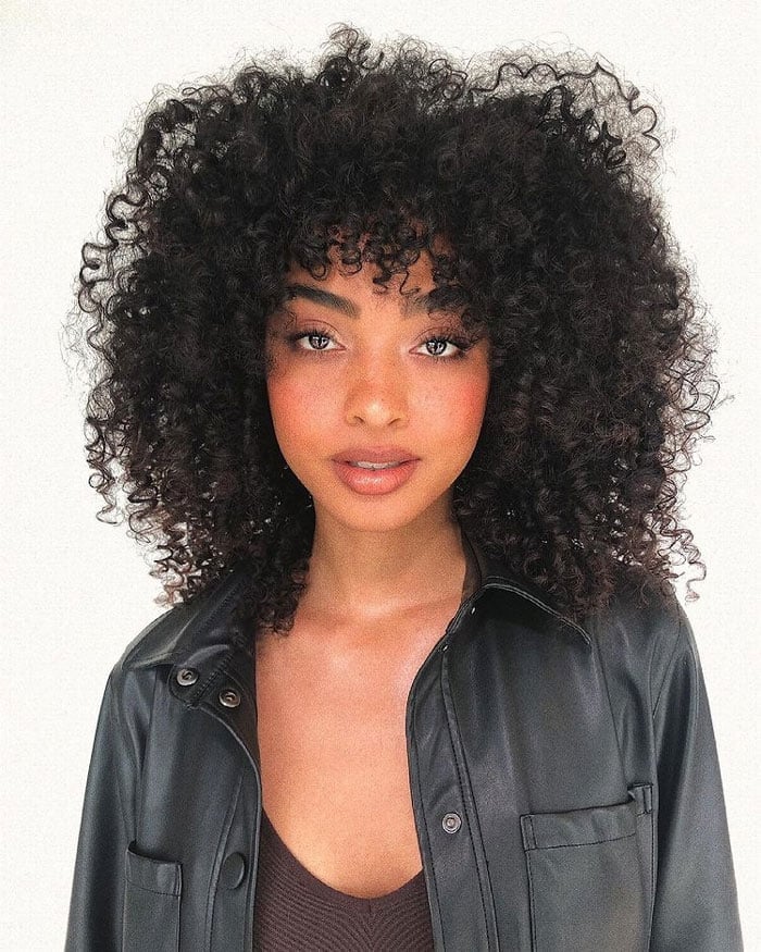 Mid-Back Length Voluminous Curls With Simple Curly Bangs