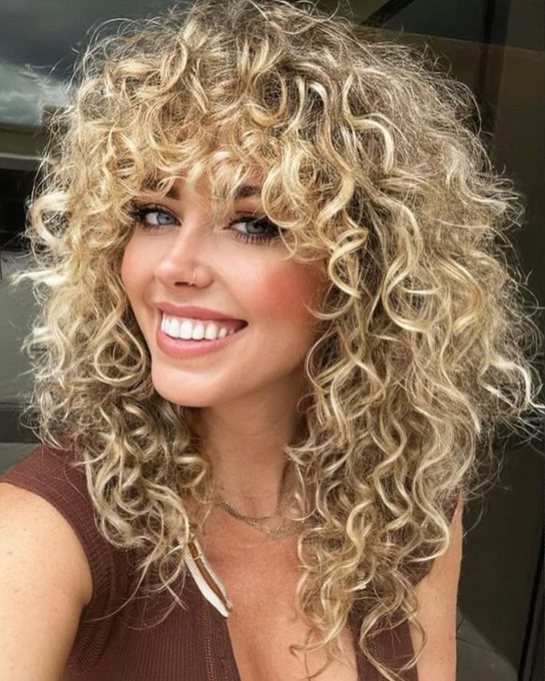 Shoulder Blonde Shag With Full Bangs Shoulder Blonde Shag With Full Bangs — Simple Curly Shag