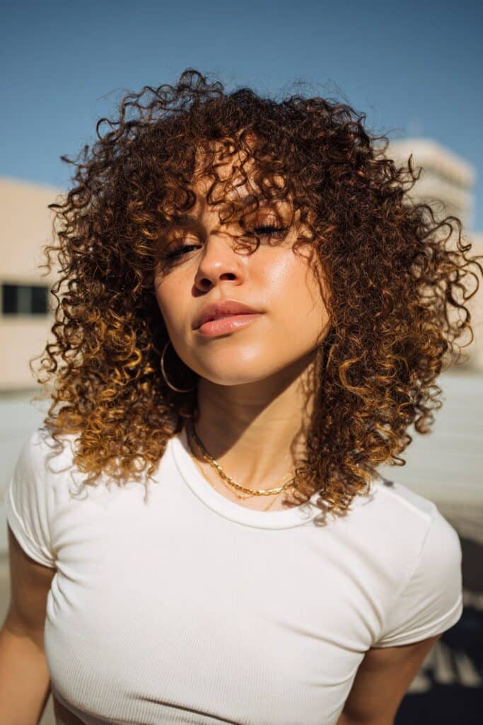 Collarbone Shag With Wispy Curly Bangs Collarbone Shag With Wispy Curly Bangs — Simple Curly Shag