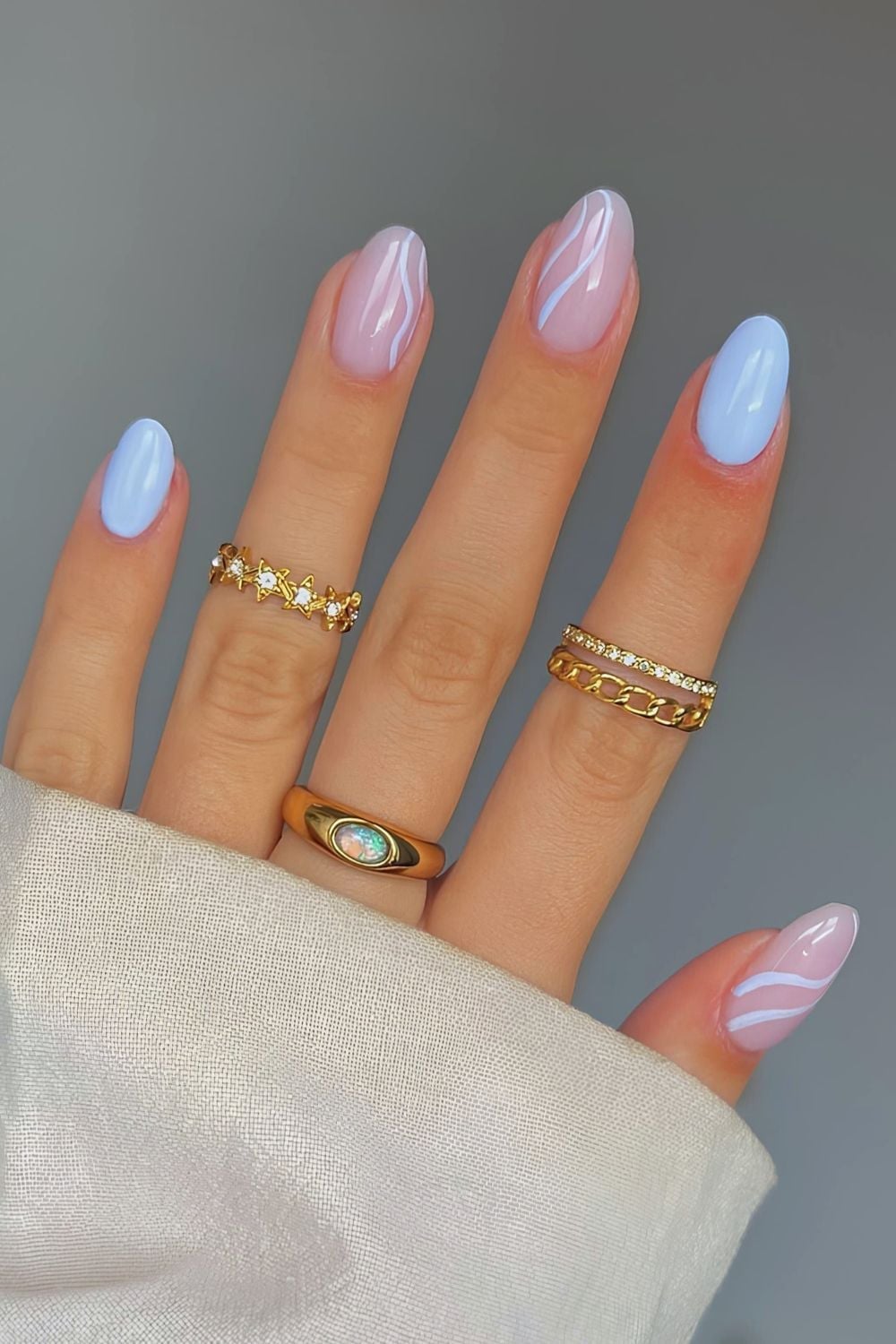 Short Almond Baby Blue With White Wavy Lines — Trendy Baby Blue Nails
