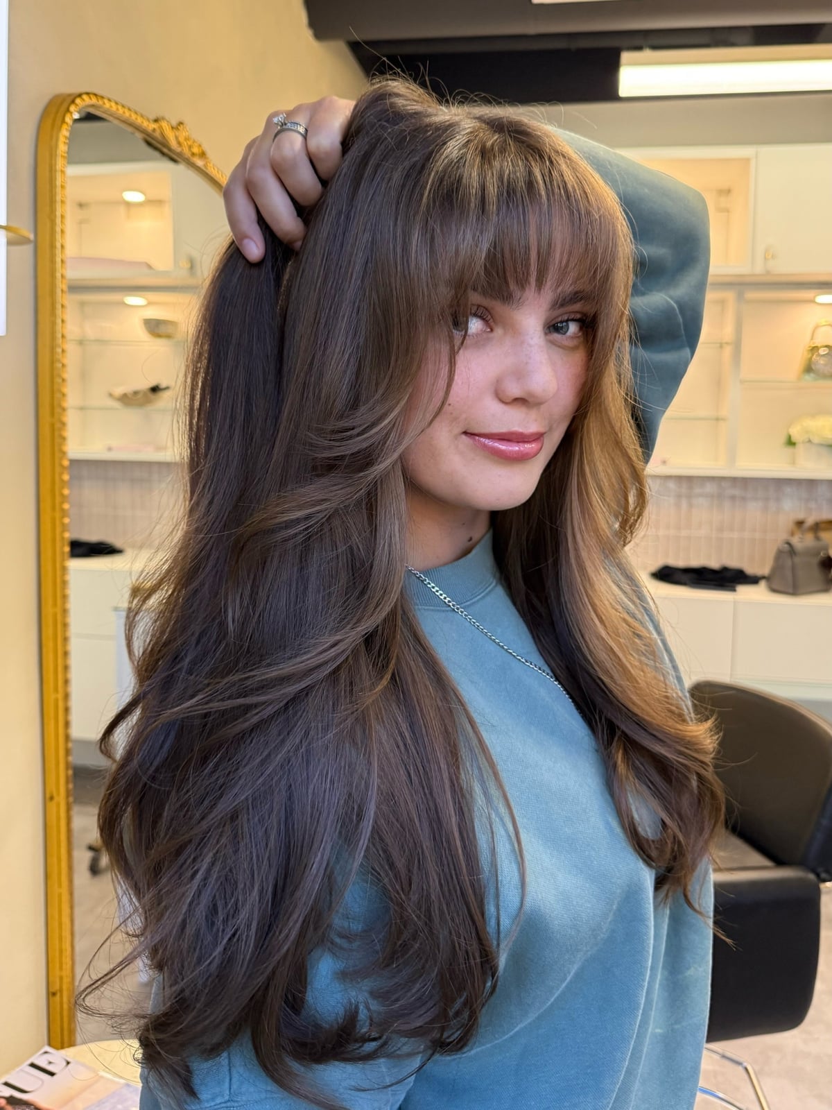 Mid-Back Wavy Layers With Full Bangs Mid-Back Wavy Layers With Full Bangs — Trendy Bangs Style