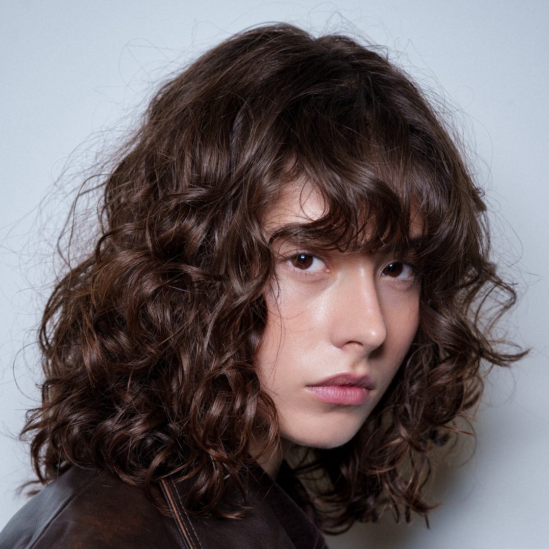 Thick Curly Shag With Choppy Bangs Thick Curly Shag With Choppy Bangs — Trendy Bangs Style