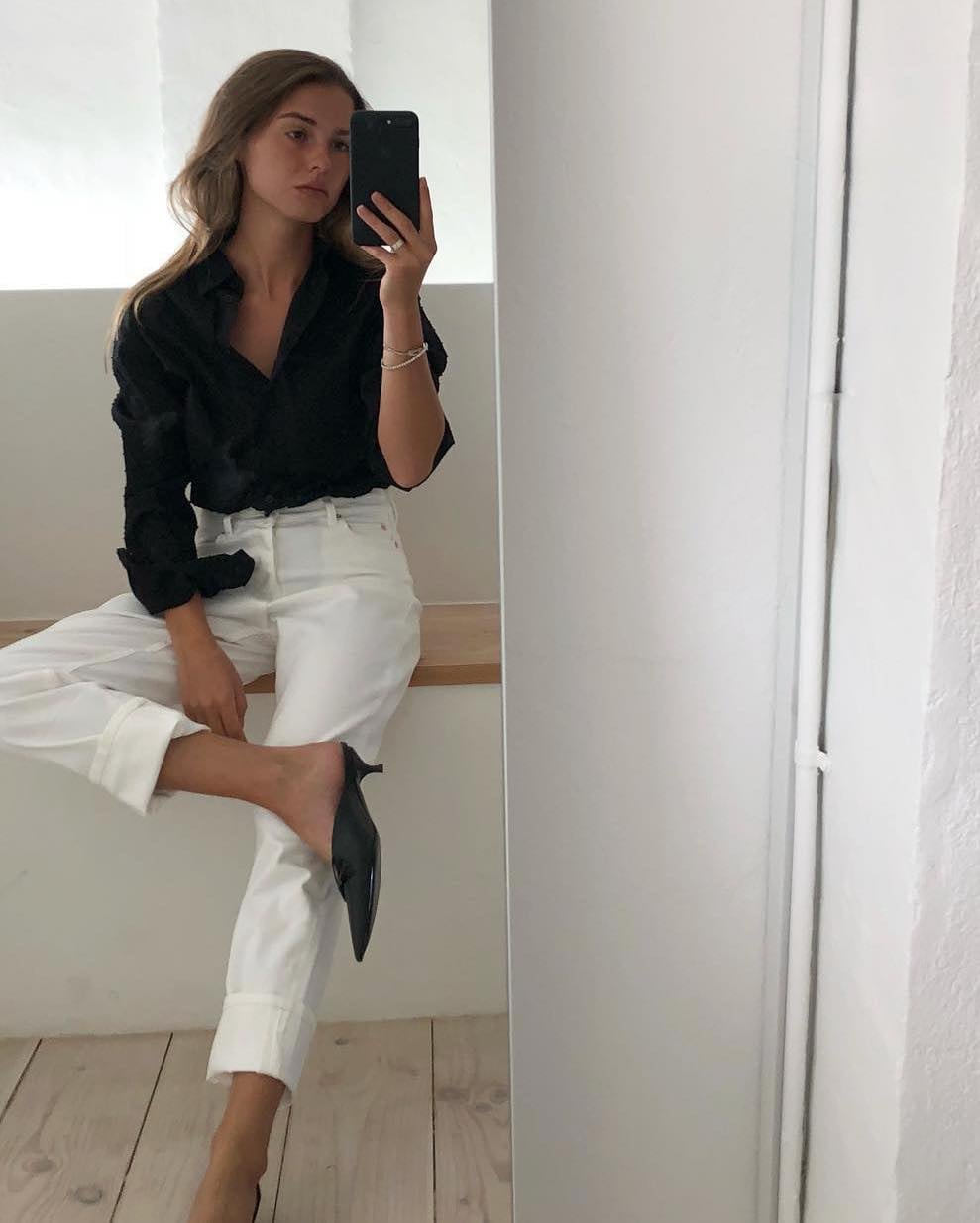 Black Shirt Tucked Into Cuffed White Jeans Black Shirt Tucked Into Cuffed White Jeans — Trendy Black and White Outfits