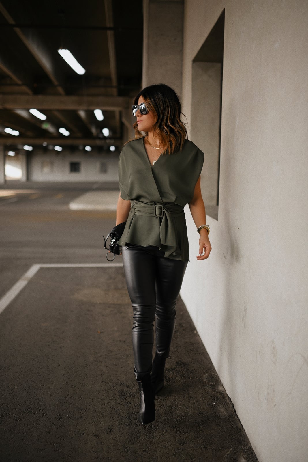 Black Leather Skinny Pants with an Olive Green Wrap Top — Trendy Black Leather Pants Outfit