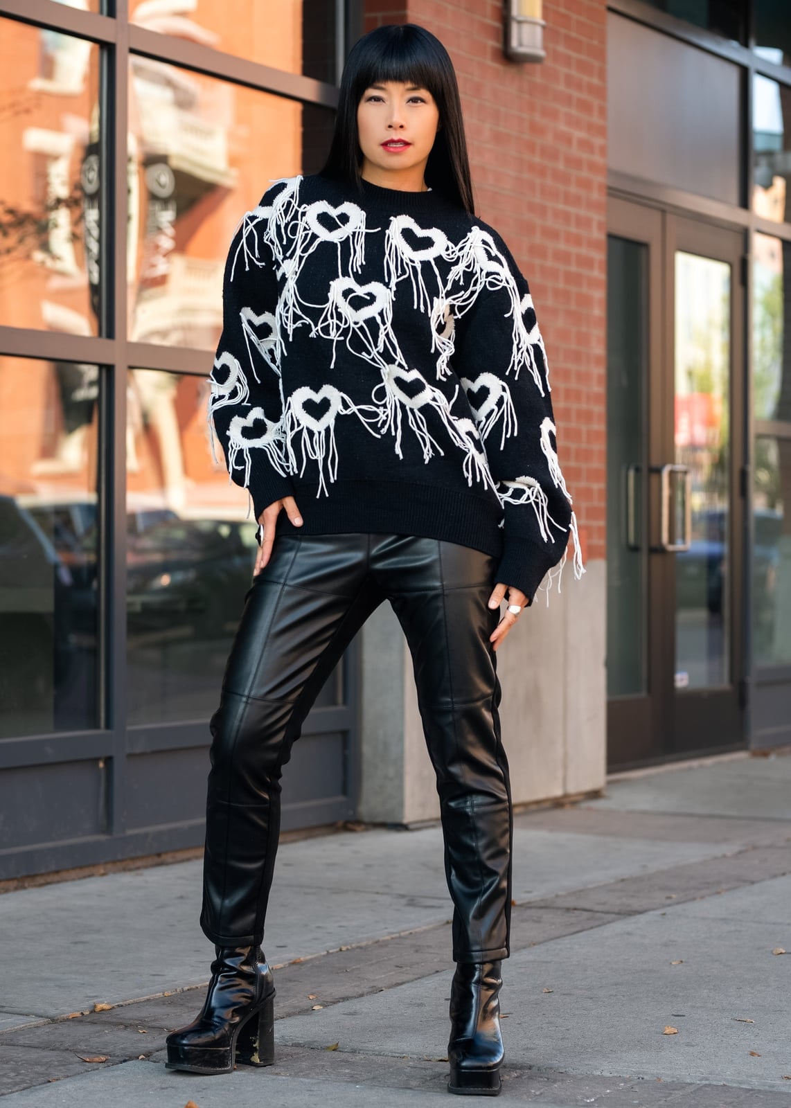 Black Leather Straight-Leg Pants with a Graphic Sweater — Trendy Black Leather Pants Outfit