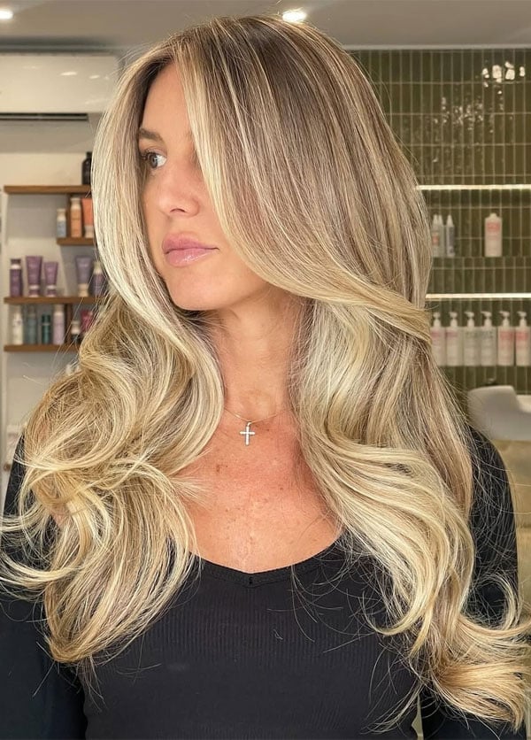 Honey Blonde Mid-Back Waves With Curtain Bangs — Trendy Blonde Hairstyles