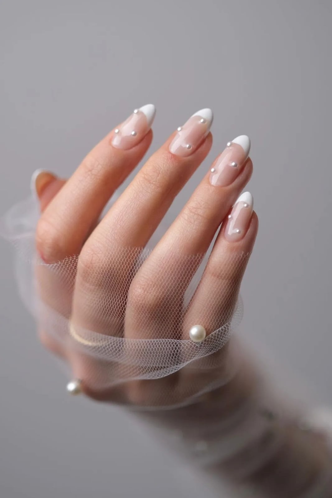 Pearl Accented French Tip Medium Almond Nails Pearl Accented French Tip Medium Almond Nails — Trendy Bride Nail