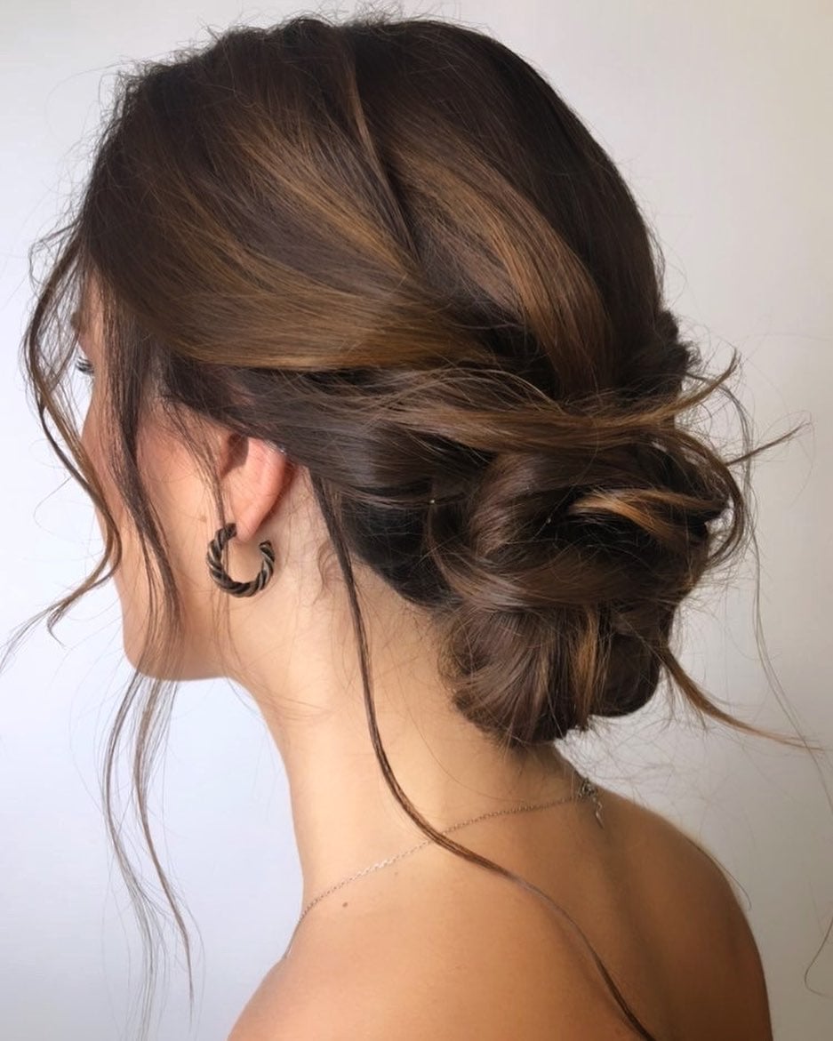 Dark Brown Textured Bun With Romantic Tendrils Dark Brown Textured Bun With Romantic Tendrils — Trendy Bridesmaid Hair Updo