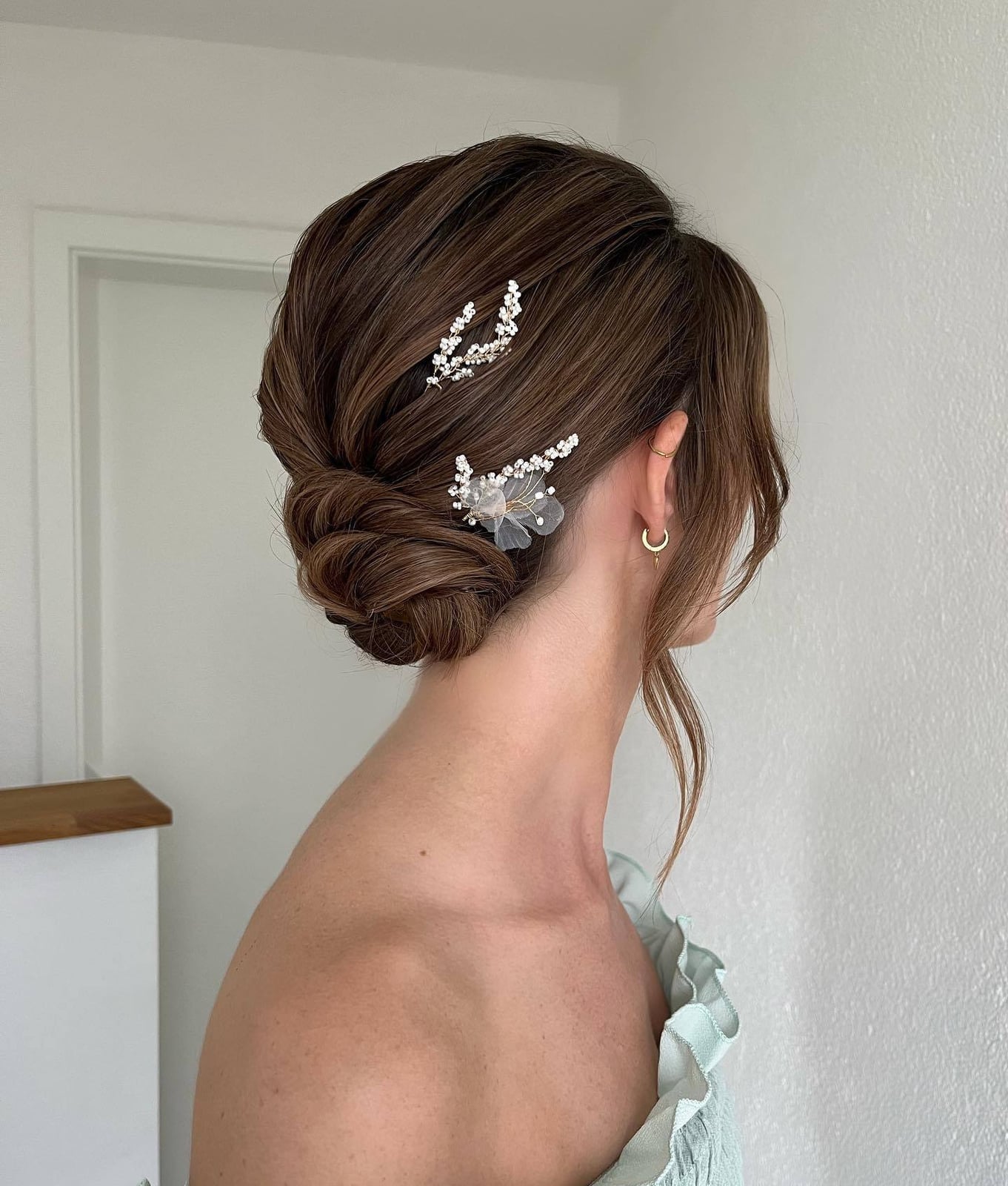 Dark Brown Twisted Bun With Decorative Pins Dark Brown Twisted Bun With Decorative Pins — Trendy Bridesmaid Hair Updo