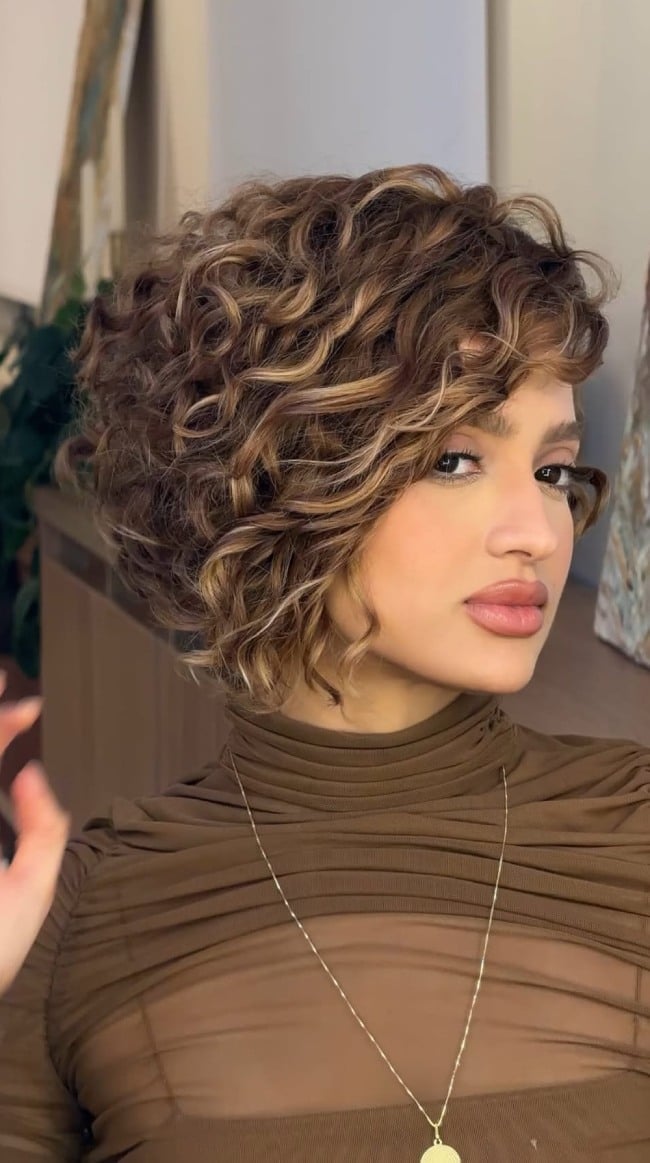 Angled Bob With Side-Swept Bangs — Trendy Brown Curly Hair