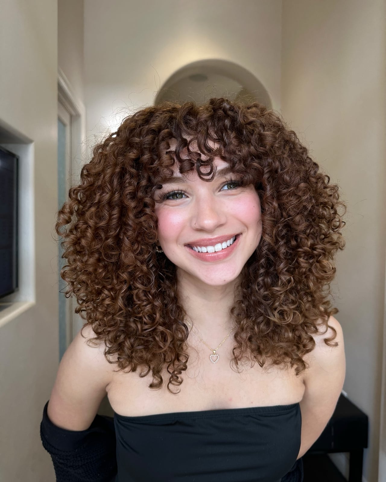 Collarbone Layers With Subtle Highlights — Trendy Brown Curly Hair